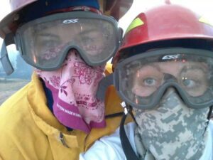 Two firefighters wearing goggles and face coverings