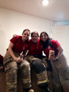 Three firefighters smiling