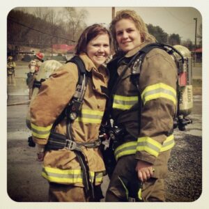 Two firefighters wearing oxygen tanks