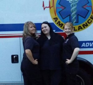 Three paramedics smiling and striking a pose